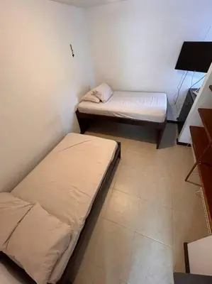 a small room with two beds and a desk at Casa Lupita Hermoso apartasol in Santa Fe de Antioquia