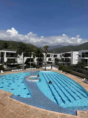 a large swimming pool with people in the water at Casa Lupita Hermoso apartasol in Santa Fe de Antioquia
