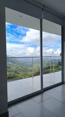 a large glass window in a building with a view at Casa Campestre Bellavista in Villamaría
