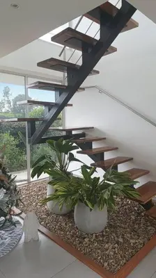 a staircase with potted plants in a living room at Casa Campestre Bellavista in Villamaría