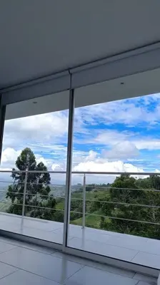 a large window in a room with a view of trees at Casa Campestre Bellavista in Villamaría
