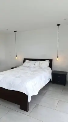 a bedroom with a large bed with white sheets at Casa Campestre Bellavista in Villamaría