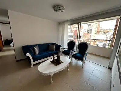 a living room with a blue couch and chairs at Bright and Modern Medellin Apartment in Medellín