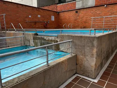 a row of swimming pools in a building at Bright and Modern Medellin Apartment in Medellín