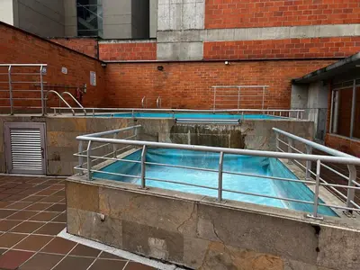 a large pool of water in a building at Bright and Modern Medellin Apartment in Medellín