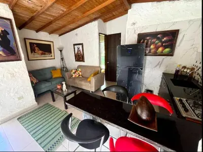 a living room with a couch and a table at Villa Arte Rustico in Ciudad Bolívar