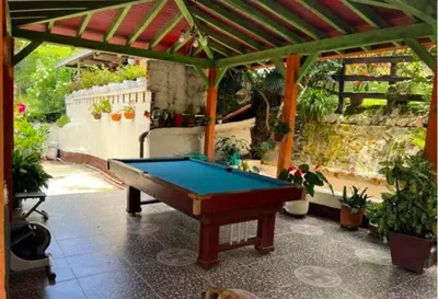 a pool table on a patio with a roof at Villa Arte Rustico in Ciudad Bolívar