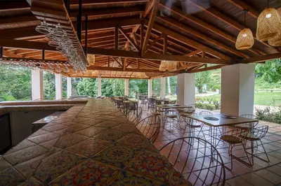 a large bar with chairs and tables in a room at Tres Lagos Hotel in San Jerónimo