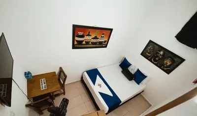 a bedroom with a bed and a picture on the wall at Hotel Lleras # 1 in Medellín