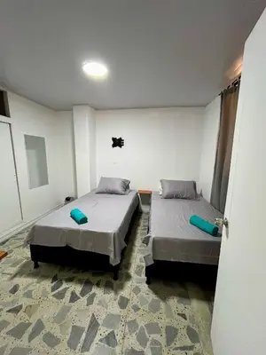 two beds in a room with two beds sidx sidx sidx at Entre Jardines in Medellín