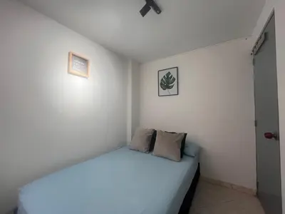 a bedroom with a bed with two pillows on it at Habitación 1 Belen san Bernando in Medellín