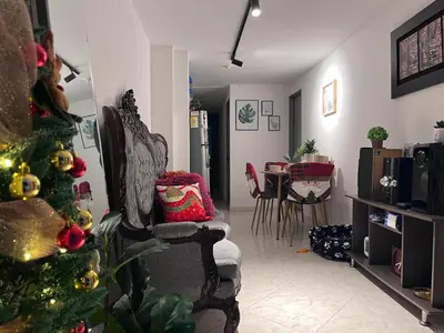 a living room with a christmas tree and a chair at Habitación 1 Belen san Bernando in Medellín
