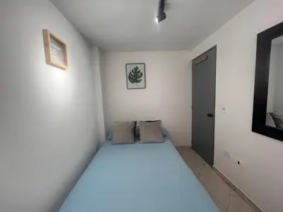 a bedroom with a large bed in a room at Habitación 1 Belen san Bernando in Medellín
