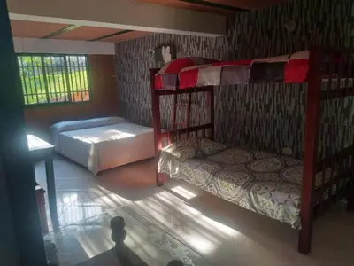 a bedroom with two bunk beds and a table at Rancho forest Victoria in Victoria