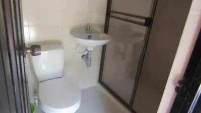a bathroom with a toilet and a sink and a shower at Rancho forest Victoria in Victoria