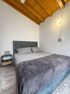 a bedroom with a large bed in a room at Party house, rooftop terrace with Jacuzzi poblado, Movie Theater in Envigado