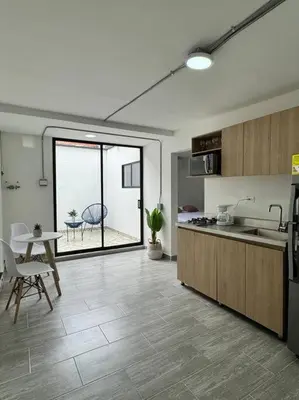 a kitchen and dining room with a table and a window at Dream apt close to Unicentro - spacious - with AC in Medellín