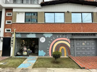 a house with a rainbow painted on the side of it at Dream apt close to Unicentro - spacious - with AC in Medellín