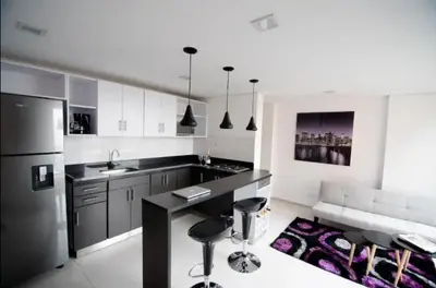 a kitchen with a black counter top and a refrigerator at Espacio Ideal para Disfrutar Medellin in Medellín