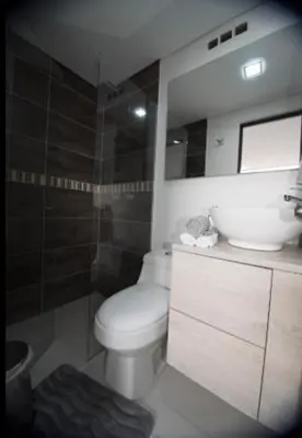 a bathroom with a toilet and a sink and a shower at Espacio Ideal para Disfrutar Medellin in Medellín