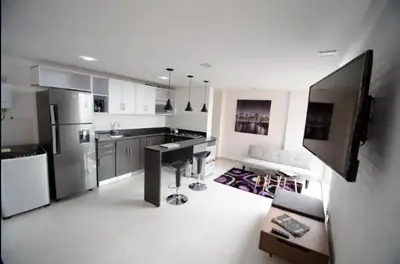 a kitchen with a refrigerator and a counter top at Espacio Ideal para Disfrutar Medellin in Medellín