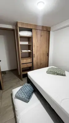 a bedroom with two beds and a closet at Mirador la casa del cóndor 3 habitaciones in Itagüí