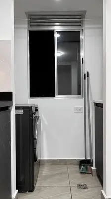 a kitchen with a window and a washer and dryer at Mirador la casa del cóndor 3 habitaciones in Itagüí