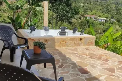a stone fountain on a patio with chairs and a table at Polandia in Villa Silvia