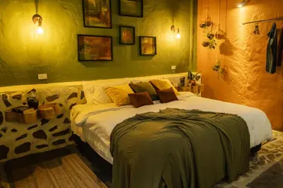 a bedroom with a large bed in a room at Peaceful rustic cabin steps from town in Jericó