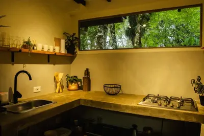 a kitchen counter with a sink and a window at Peaceful rustic cabin steps from town in Jericó