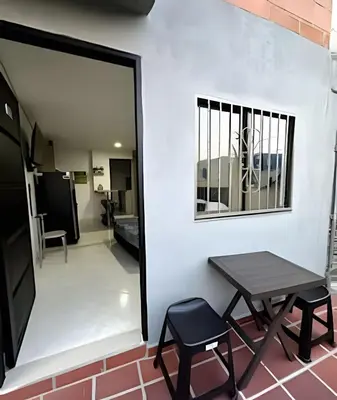 a table and two chairs next to a white wall at 9804 · 9804 Loft Env. good view local experience confort in Envigado