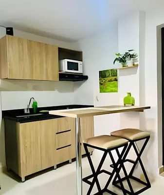 a kitchen with a counter and two stools at 9804 · 9804 Loft Env. good view local experience confort in Envigado