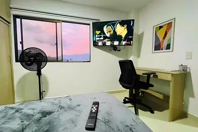 a bedroom with a desk and a chair and a fan at 9903 Vista al sur de la ciudad para 2 in Envigado