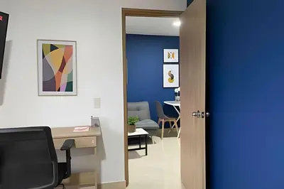 an office with a blue door and a desk at 9903 Vista al sur de la ciudad para 2 in Envigado
