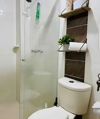 a bathroom with a toilet and a glass shower at 9903 Vista al sur de la ciudad para 2 in Envigado