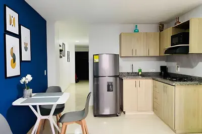a kitchen with a refrigerator and a table and chairs at 9903 Vista al sur de la ciudad para 2 in Envigado