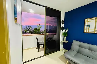 a living room with a blue accent wall at 9903 Vista al sur de la ciudad para 2 in Envigado