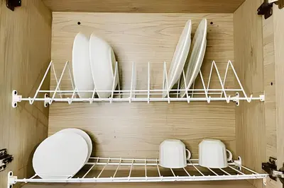 a kitchen with a shelf with plates and toasters at 9902Aparta estudio totalmente dotado WiFi200 megas in Envigado