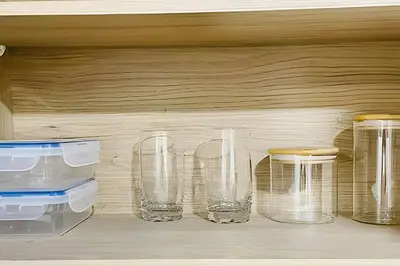 a row of glasses sitting on a wooden shelf at 9902Aparta estudio totalmente dotado WiFi200 megas in Envigado