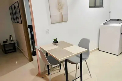 a table and chairs in a kitchen with a refrigerator at 9902Aparta estudio totalmente dotado WiFi200 megas in Envigado
