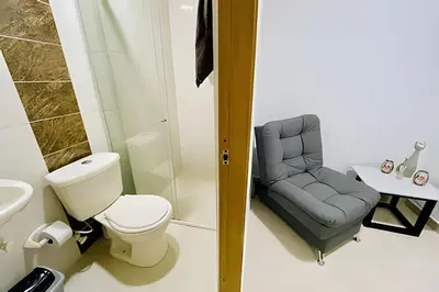 a bathroom with a toilet and a chair at 9902Aparta estudio totalmente dotado WiFi200 megas in Envigado