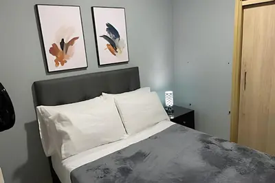 a bedroom with a bed with three pictures on the wall at 9902Aparta estudio totalmente dotado WiFi200 megas in Envigado