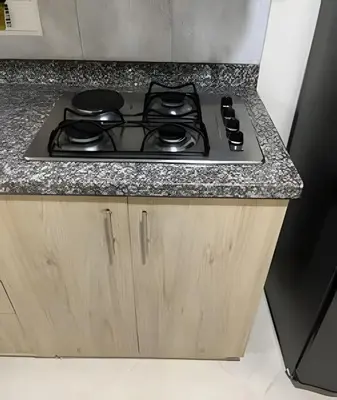 a stove top oven sitting on top of a counter at 9904 Acogedor y cómodo aparta estudio dotado in Envigado