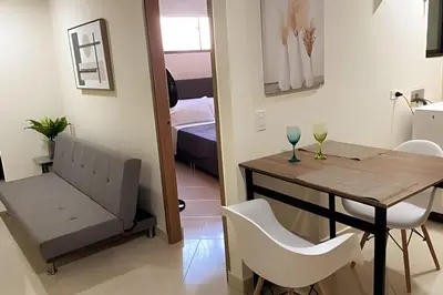 a small room with a table and chairs and a bedroom at 9904 Acogedor y cómodo aparta estudio dotado in Envigado