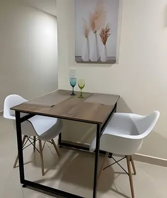 a dining room table with two glasses and two chairs at 9904 Acogedor y cómodo aparta estudio dotado in Envigado