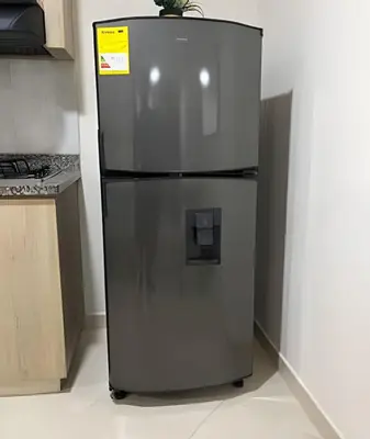 a refrigerator in a kitchen with a sign on it at 9904 Acogedor y cómodo aparta estudio dotado in Envigado