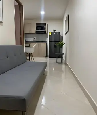 a living room with a couch and a kitchen at 9904 Acogedor y cómodo aparta estudio dotado in Envigado