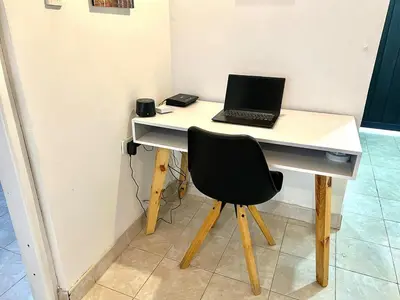 a desk with a laptop computer on top of it at Casa Tradicional Remodelada en Envigado con Patio in Envigado