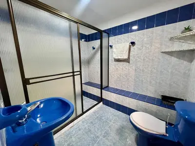 a bathroom with a blue sink and a toilet at Casa Tradicional Remodelada en Envigado con Patio in Envigado