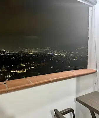 a window seat with a view of a city at beautiful view of the city with local experience in Envigado